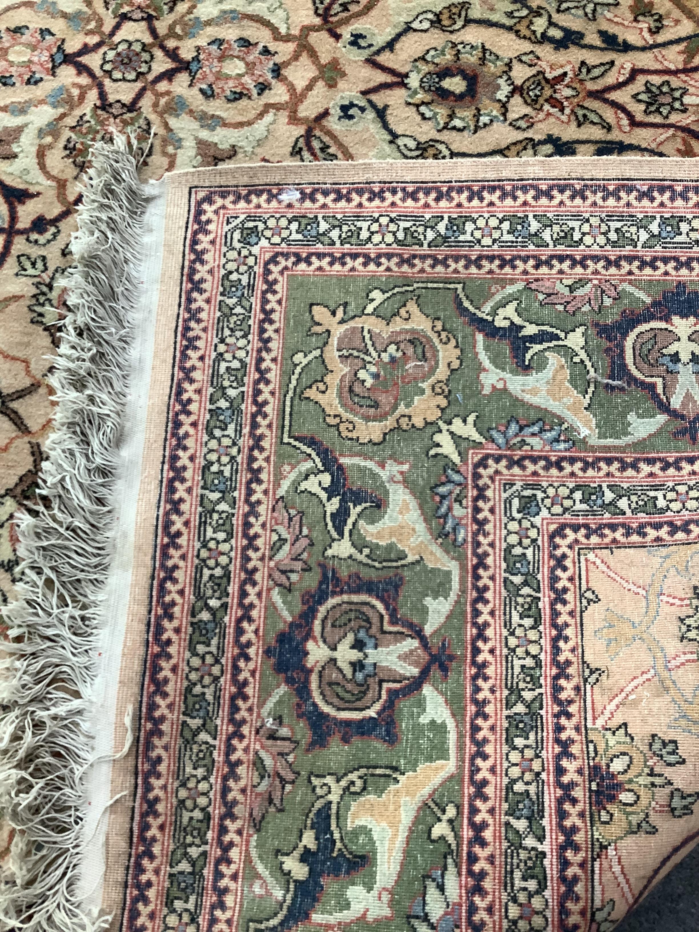 A North West Persian style peach ground carpet, 306 x 205cm
